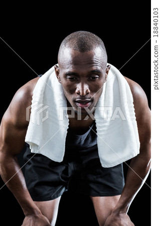 Muscular man resting while keeping hand on knee Muscular man resting while keeping hand on knee 18840103