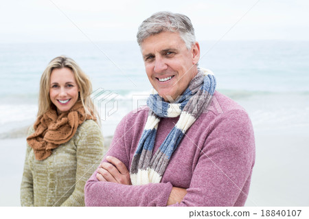 Happy couple standing beside one another 18840107