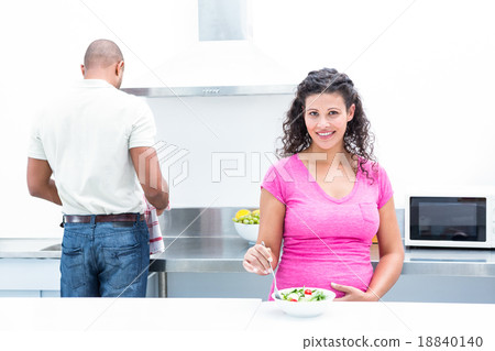 Portrait of happy wife with husband helping in kitchen 18840140