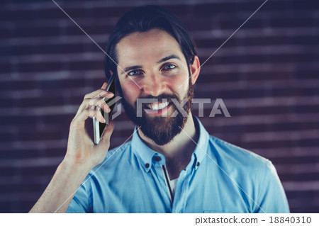 Portrait of smiling hipster using smartphone Portrait of smiling hipster using smartphone 18840310