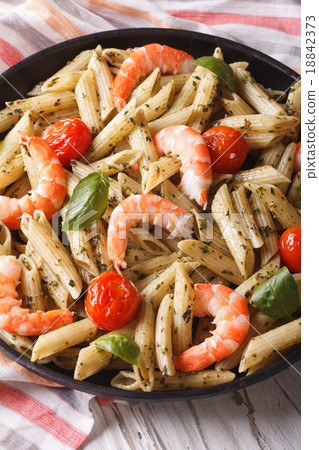 penne pasta with shrimp, tomato and pesto closeup 18842373