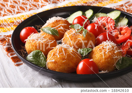 Fried rice balls and fresh vegetable salad 18842610