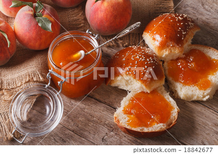 peach jam and sweet buns close-up on the table peach jam and sweet buns close-up on the table 18842677