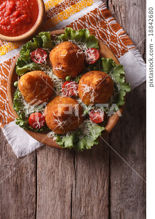 Arancini rice balls stuffed with meat and sauce 18842680