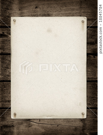 Old textured paper sheet on a dark wood table Old textured paper sheet on a dark wood table 18845784