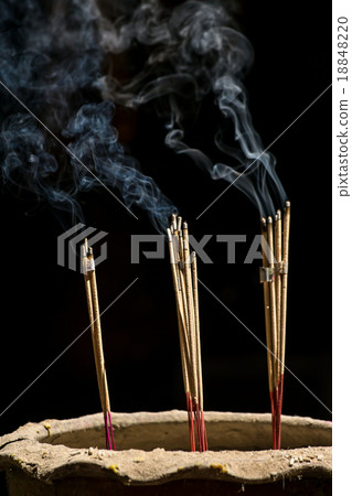 Incense sticks with smoke against black background 18848220