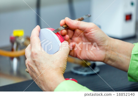Dental technician working in dental laboratory 18852140
