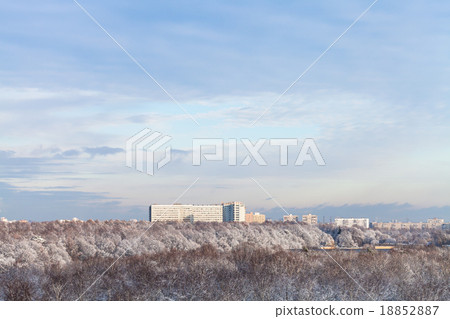 blue clouds in blue sky over snow forest and town 18852887