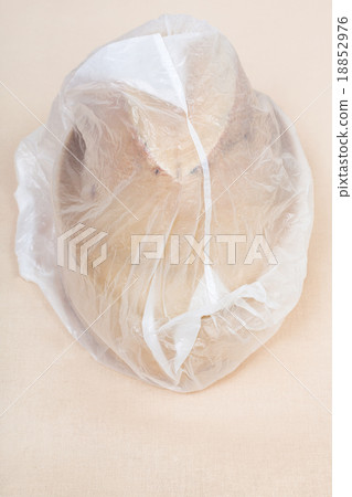 wooden hat-block wrapped in plastic wrap 18852976