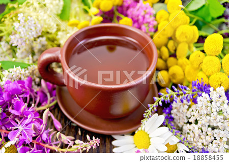 Tea from flowers in clay cup on board 18858455