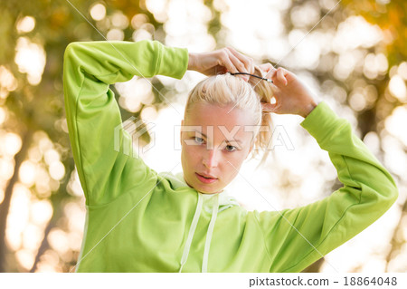 Sporty woman wearing fashionable green hoodie.  Sporty woman wearing fashionable green hoodie.  18864048