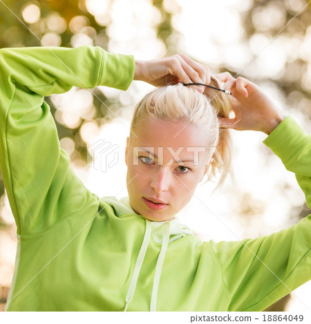 Sporty woman wearing fashionable green hoodie.  Sporty woman wearing fashionable green hoodie.  18864049