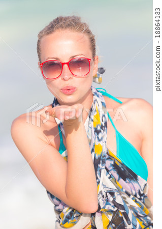 Woman sending a kiss from summer vacations. Woman sending a kiss from summer vacations. 18864183