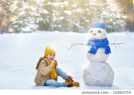 girl playing with a snowman 18864704