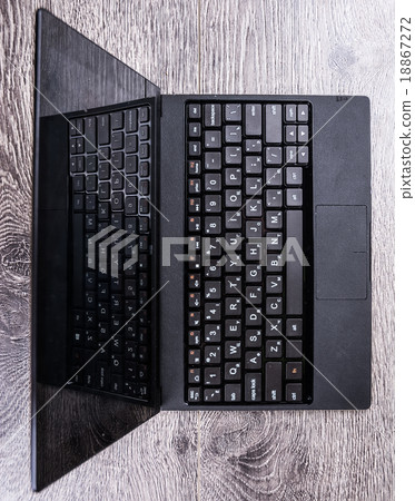 black laptop on wood 18867272