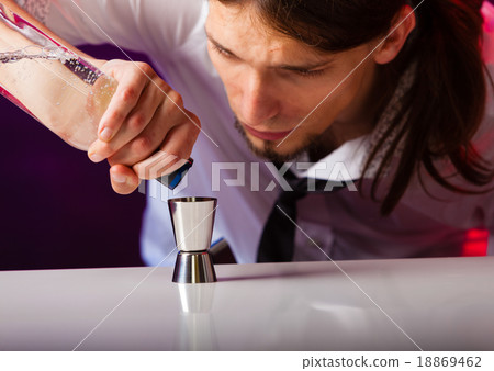 Young man bartender preparing alcohol drink 18869462