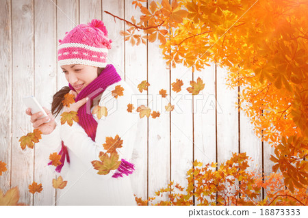 Composite image of attractive woman using her smartphone 18873333