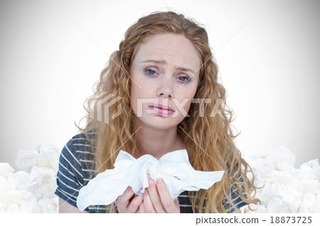 Composite image of portrait of sick woman holding paper tissue Composite image of portrait of sick woman holding paper tissue 18873725