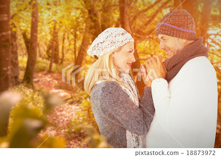 Composite image of cute smiling couple holding hands Composite image of cute smiling couple holding hands 18873972