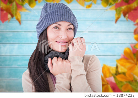 Composite image of attractive brunette looking up wearing warm c Composite image of attractive brunette looking up wearing warm c 18874222