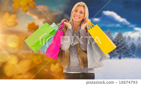 Composite image of blonde in winter clothes holding shopping bag Composite image of blonde in winter clothes holding shopping bag 18874793