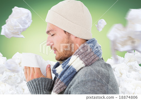 Composite image of handsome man in winter fashion blowing his no Composite image of handsome man in winter fashion blowing his no 18874806
