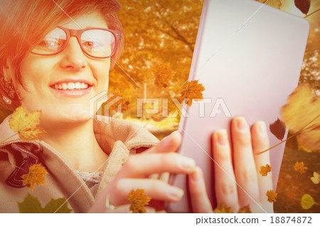 Composite image of portrait of smiling woman in glasses using ta Composite image of portrait of smiling woman in glasses using ta 18874872