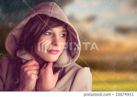 Composite image of beautiful woman wearing winter coat looking a 18874931