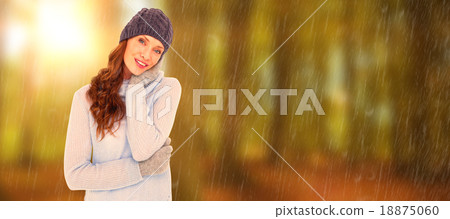 Composite image of pretty redhead in warm clothing 18875060