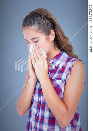 Composite image of sick woman sneezing in a tissue Composite image of sick woman sneezing in a tissue 18875261