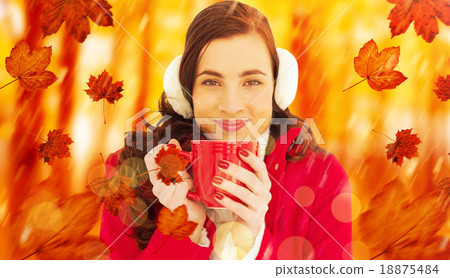 Composite image of woman in winter clothes enjoying a hot drink 18875484