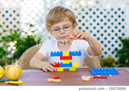 Little kid boy playing with plastic blocks 18878690