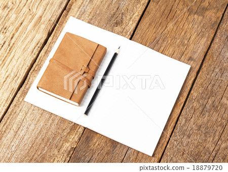 Blank open notebook with black pencil on wood Blank open notebook with black pencil on wood 18879720