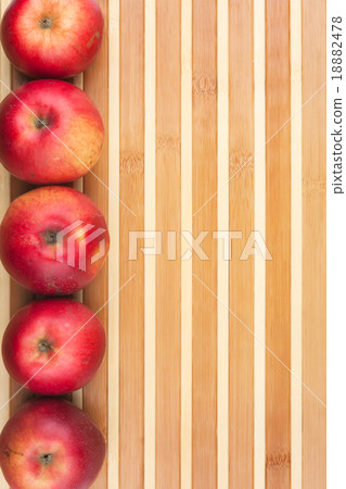 red  apples lie on  bamboo mat 18882478