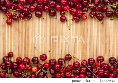 Cherry lying on bamboo mat Cherry lying on bamboo mat 18882658