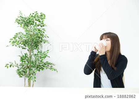 A woman drinking hot drinks 18882862