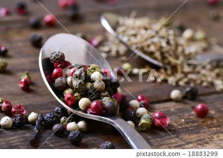 spoon with a variety of peppercorns spoon with a variety of peppercorns 18883299