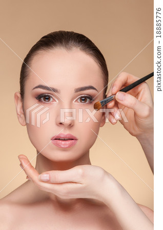 Skillful female visagiste is serving her customer 18885776