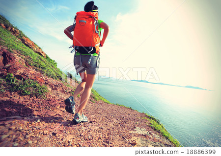 young woman backpacker walking on seaside   18886399