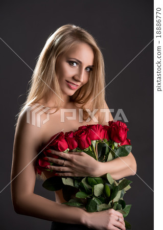 Smiling topless blonde with bouquet of roses 18886770