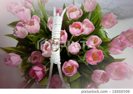 Pink tulips in the basket with wedding rings 18888506