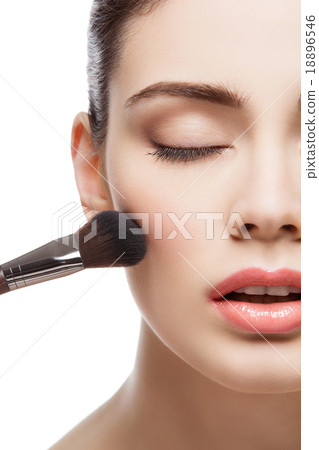Beautiful girl applying blush with brush Beautiful girl applying blush with brush 18896546