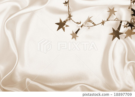 Golden stars and spangles on silk as background. 18897709