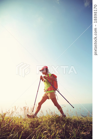 young woman hiker hiking on seaside mountain trail 18898170