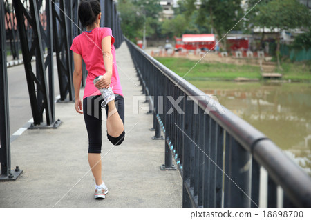 young fitness woman stretching legs before run young fitness woman stretching legs before run 18898700