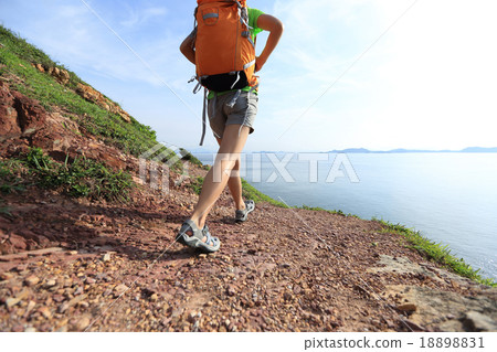 young woman backpacker walking on seaside young woman backpacker walking on seaside 18898831