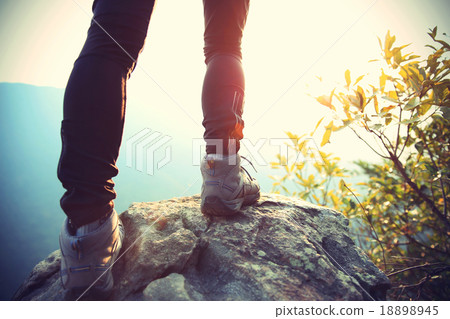 woman hiker legs on mountain peak rock 18898945