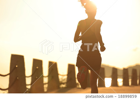 fitness woman running on sunrise seaside trail fitness woman running on sunrise seaside trail 18899859