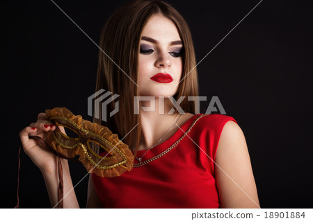 Pretty girl is holding carnival mask Pretty girl is holding carnival mask 18901884