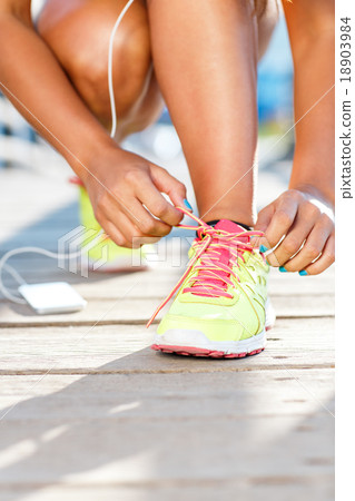 Running shoes - woman tying shoe laces 18903984